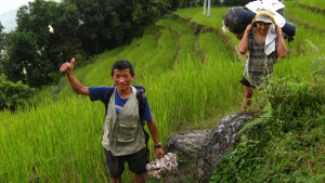 Head Cook Manbakta, and Porter Suriya, navigating a mountainside rice paddy